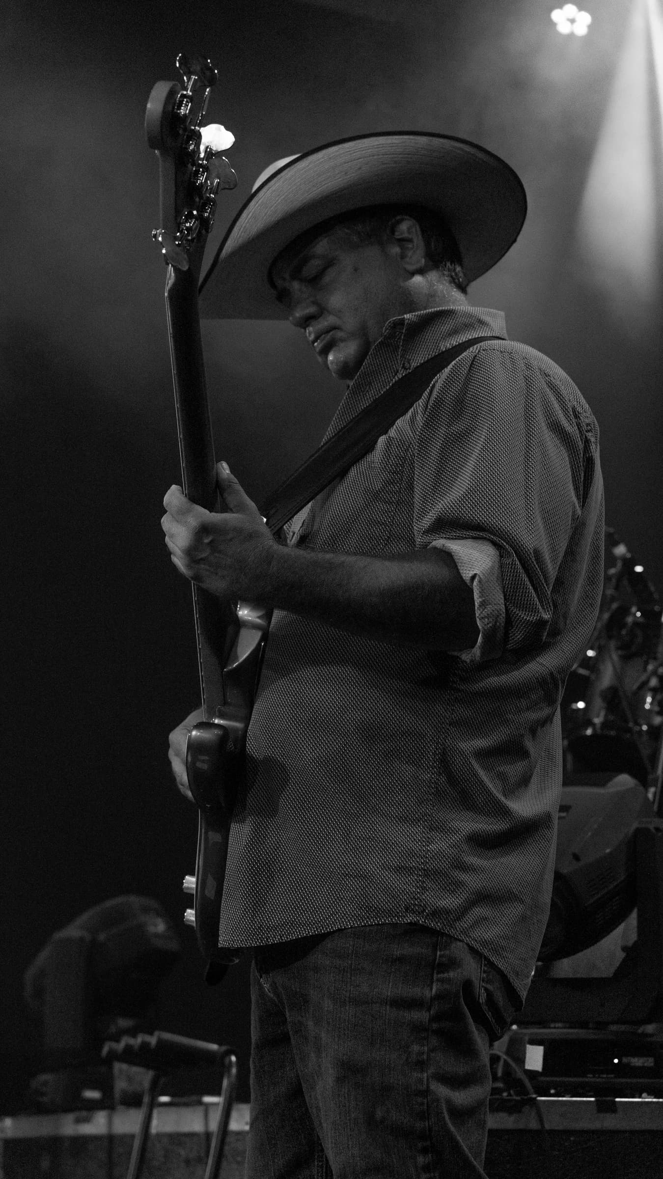 Buck Ford at the microphone in a black-and-white side-stage portrait
