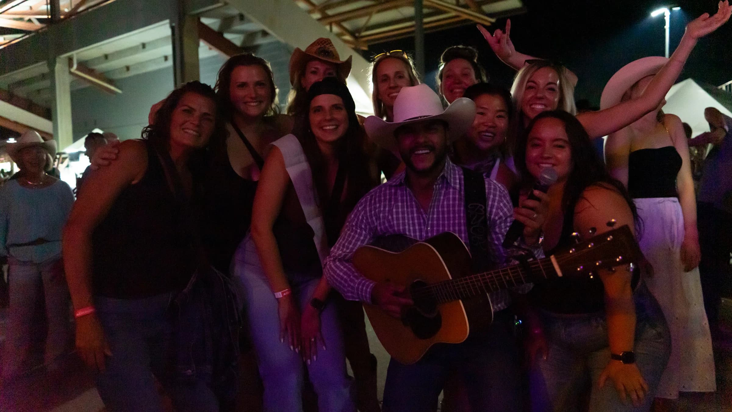 Buck Ford posing with a group of concertgoers