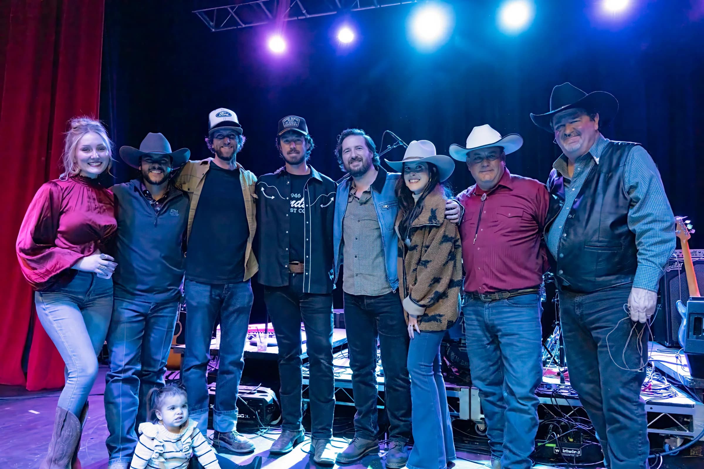 Buck Ford and a group gathered for a photo beside the stage